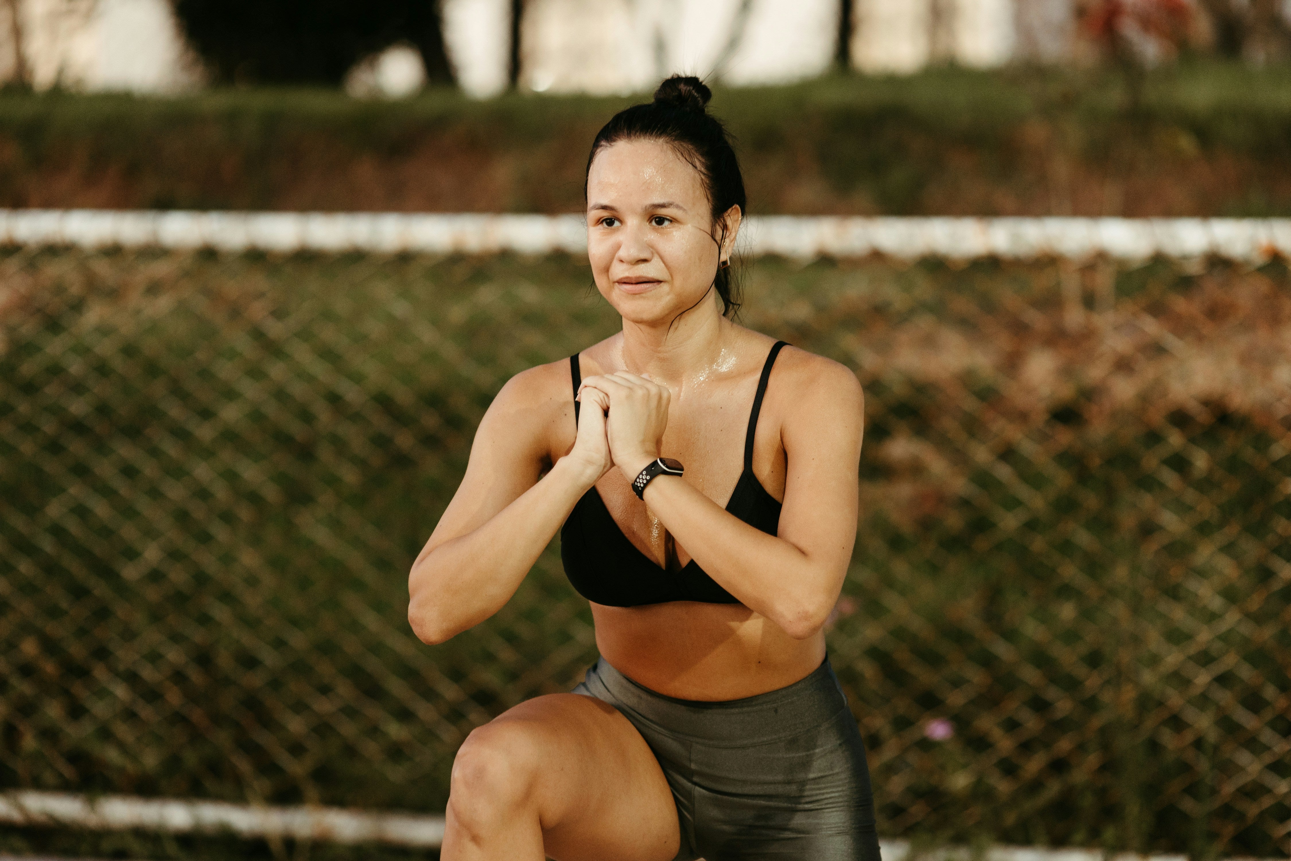 Woman doing squats outdoors